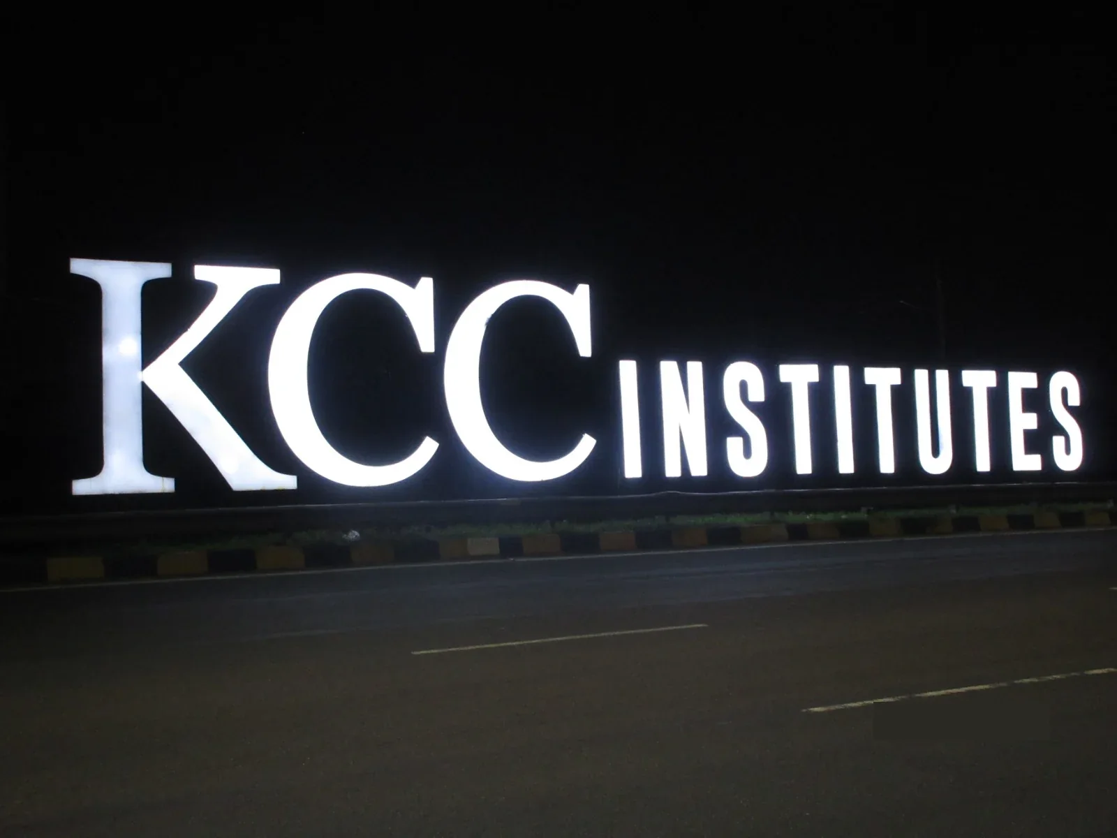KCC Institutes — The letters lit up after dark — site photo